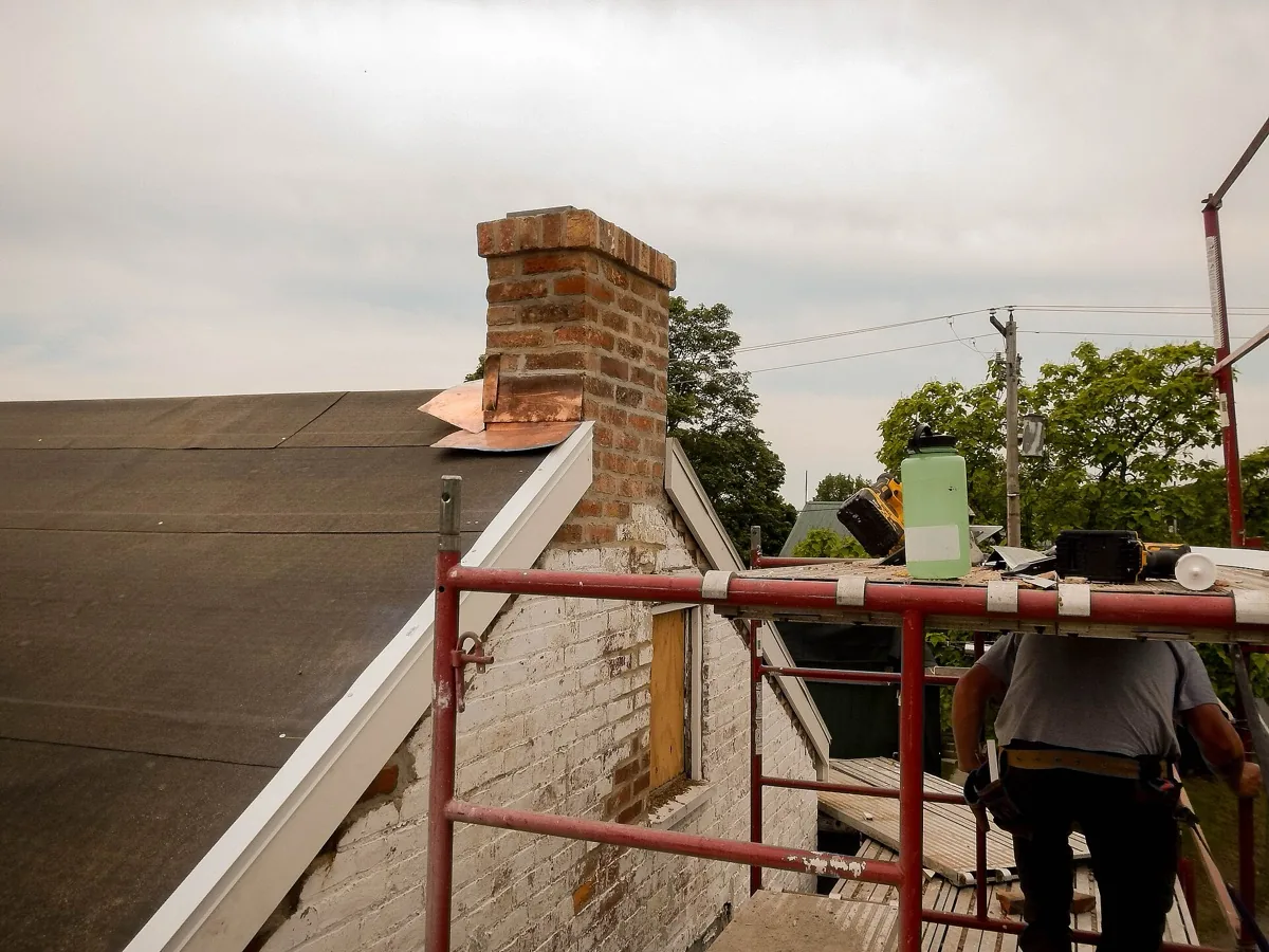 Brick chimney rebuild with new copper flashing