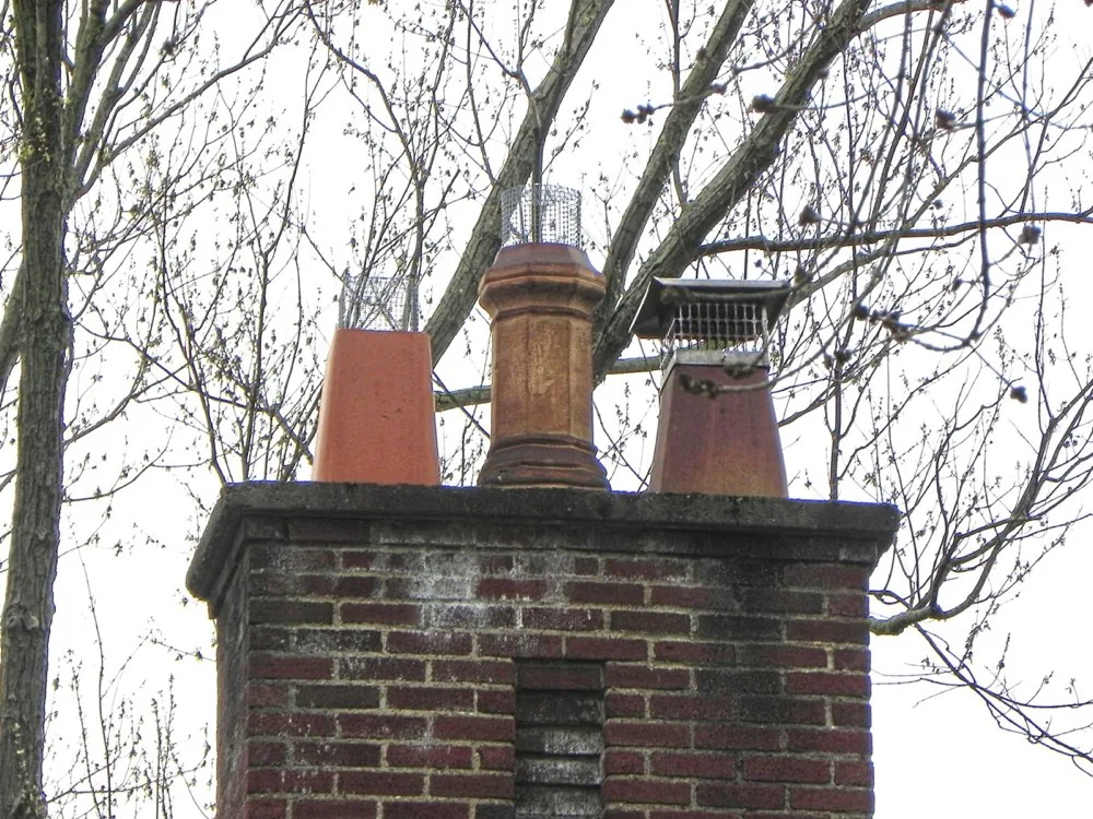 Chimney crown with clay flue pots and spark guards