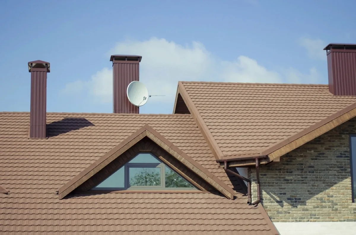 Metal-clad chimneys on a tiled roof