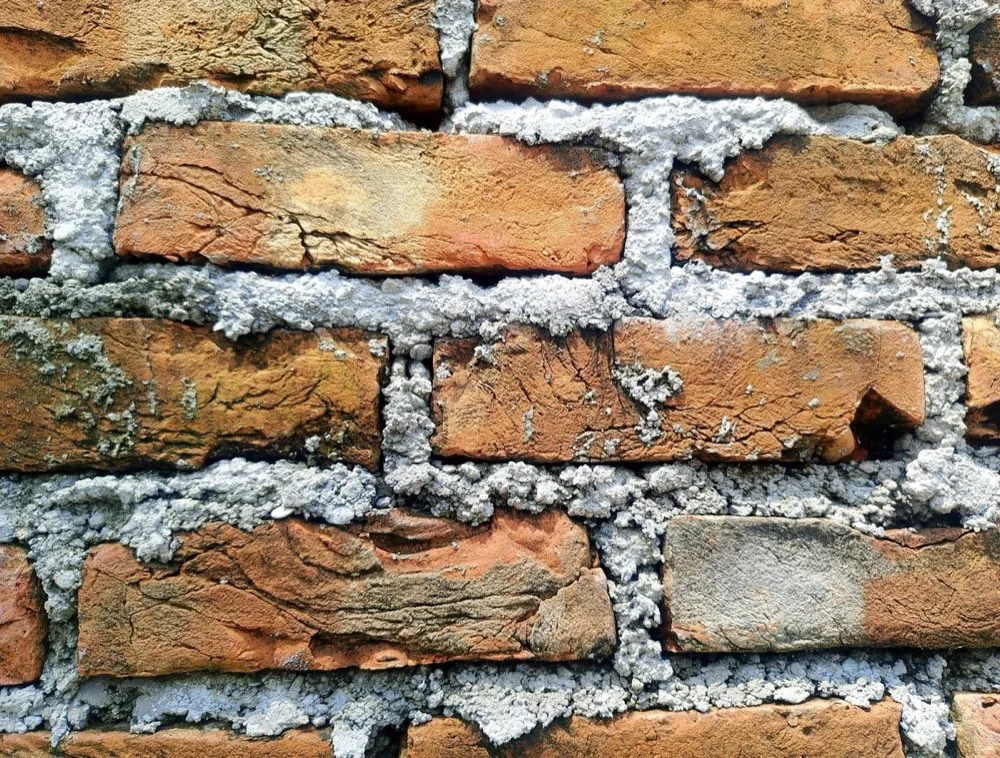 Aging brick wall with deteriorating mortar